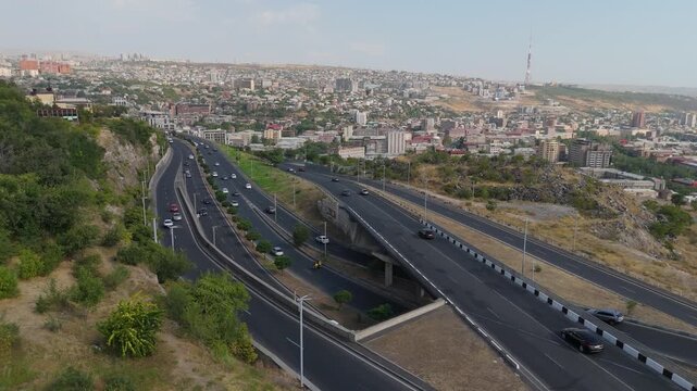 31.08.2025 Yerevan Armenia. Drone fly over traffik road with cars. Vehicles, cars, traffic during day time. Road in Yerevan shows various vehicles and city skyline under bright sunlight.