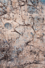 A close-up photo of an hand-woven decorative wool carpet. Texture of clean brand new rug surface with various shapes and colors as background. Top view.