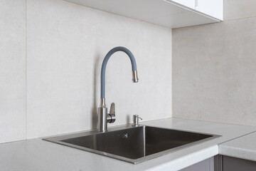kitchen faucet on a stylish metal sink