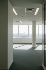 Fototapeta premium Modern empty office space with large windows and bright lighting