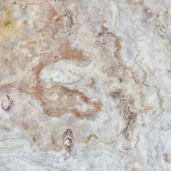 Natural stone texture with earthy tones of gray and rusty orange, showcasing rough surface patterns and organic details, ideal for backgrounds or design