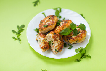 Chicken cutlets fried until crisp isolated on a green background