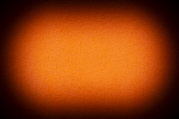 blank backdrop for Halloween card: close up of stained in orange color paper with shadowed edges