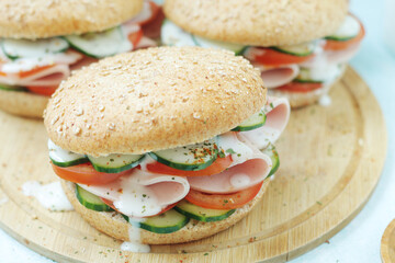 Bun sandwiches with salami and vegetables	