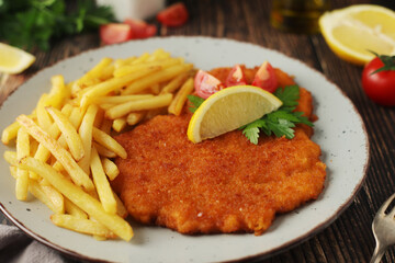 A Viennese schnizel with french fries	