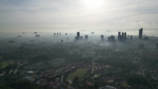 A city with a foggy sky. The sky is gray and the city is full of buildings. Aerial view Larkin, Johor