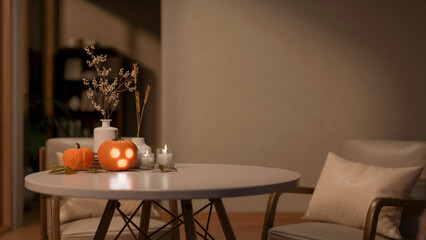 Glowing jack-o-lantern halloween pumpkin and candles on round table with armchair in dim living room