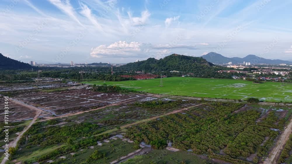 Aufkleber a large field wetland with a few houses in the background. the houses are in the distance and are no