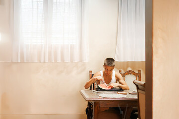 Teenage Boy Eating Fresh Watermelon Indoors During a Healthy Snack Break.