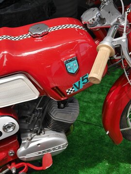 Red Sachs V5 motorcycle with checkered decoration posing on green turf
