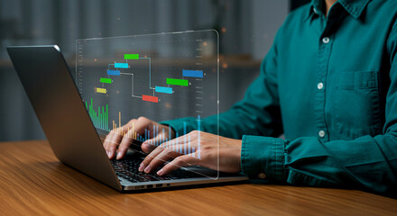 Person using laptop with transparent screen displaying charts and data visualization at desk top 100
