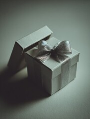 Open white gift box with silver ribbon