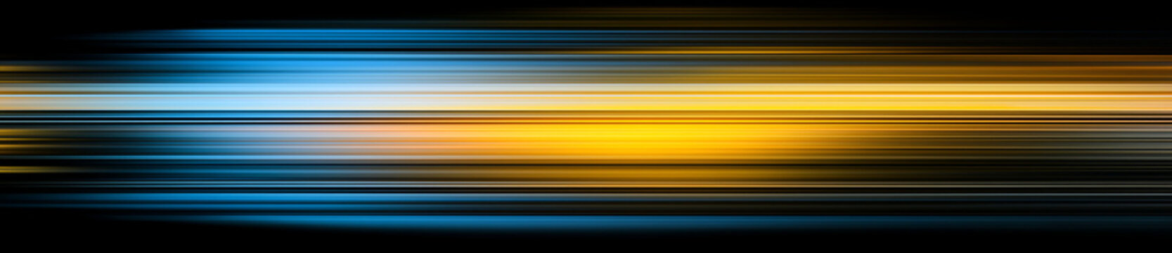 Blurry yellow and blue light streaks on abstract background