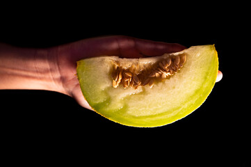 Slice of Yellow Melon on Dark Background