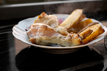 Baked Chicken Drumsticks with Potatoes on Plate