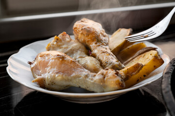 Baked Chicken Drumsticks with Potatoes on Plate