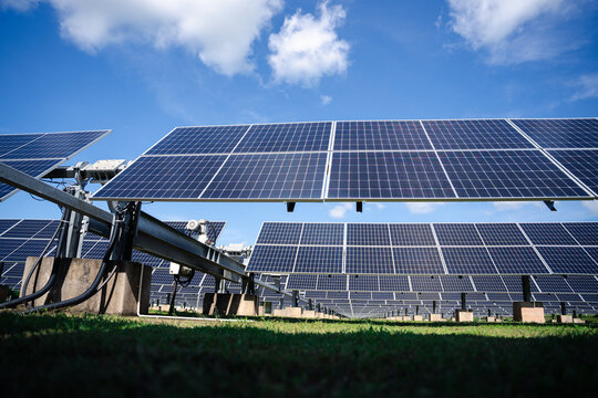 Ground-mounted solar panels with sturdy metal framing and wiring system, engineered for efficient large-scale outdoor renewable power generation in farms and industrial fields
