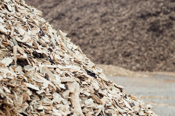 The photo shows a close-up of mountains of wood chips
