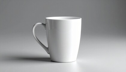 Obraz premium Plain white ceramic mug with a slightly tapered cylindrical shape and curved handle, placed on a smooth light gray surface with soft lighting and subtle shadow—emphasizing minimalist design, modern ki