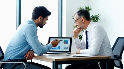 Dynamic business team reviewing data analytics on laptop in bright office for strategic growth - Powered by Adobe