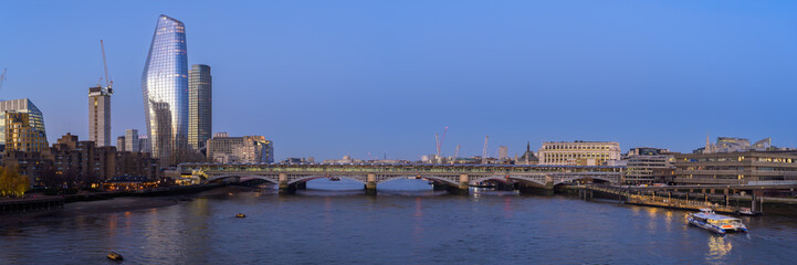 Beautiful sunrise over the Thames River highlighting London's skyline and serene waters