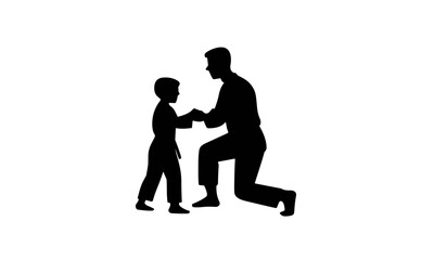 Silhouette of a man kneeling and holding the hands of a young boy in a martial arts uniform, isolated on a white background.