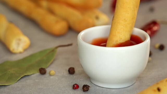 Close up of bread stick dips in ketchup sauce. Toast crouton snack. Food. Fast food
