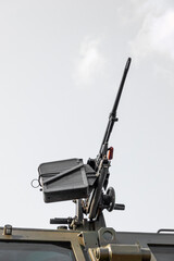 Automatic machine gun on a military armored vehicle