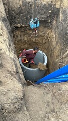 A man sets rings for a well