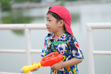 Children playing Songkran use water guns.