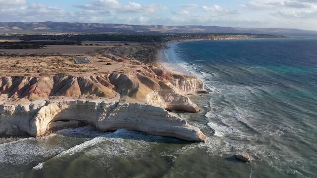 Fast aerial orbit of Blanche Point cliffs and sandstone coastline, Port Willunga, Adelaide, South Australia
