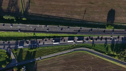 Traffic jam, commuting on the public highway. Traffic congestion. North Italy. Aerial top down view. - Powered by Adobe