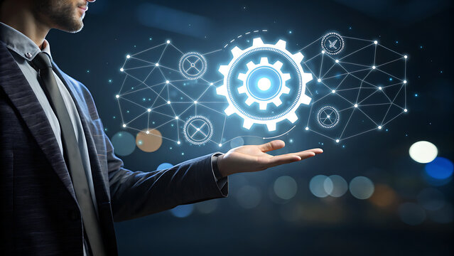 Closeup of a businessmans hand presenting a glowing gear mechanism within a digital network, representing teamwork, engineering, and operational excellence