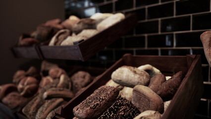 A collection of different types and varieties of bread neatly arranged and stored in a box on store shelves.