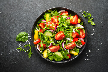 Salad with leaves, tomatoes, pepper and olive oil.
