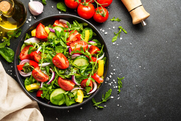 Salad with leaves, tomatoes, pepper and olive oil.