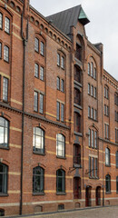 A Multi-story Red Brick Warehouse With Arched Windows 