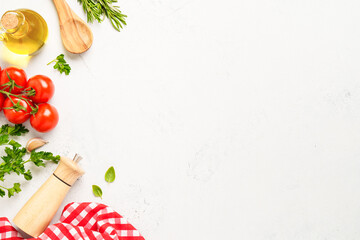 Spices, herbs and vegetables with olive oil on white kitchen table.