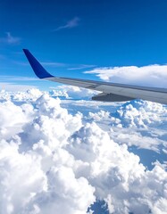 Obraz premium Airplane wing over a vast expanse of clouds
