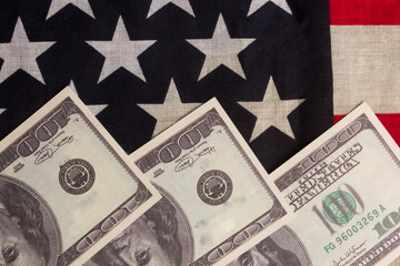One hundred US dollars and an American flag