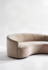A sleek, modern curved sofa upholstered in soft beige velvet, a minimalist and elegant piece of furniture for a contemporary living room interior with copy space.
