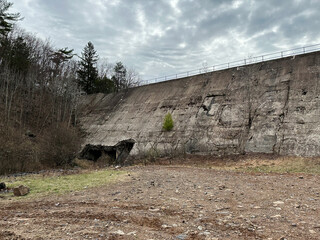 Concrete dam with surrounding plants and cloudy sky in Pennsylvania landscape