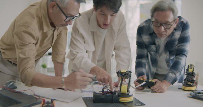 Elderly students guided by a young mentor in robotics and AI STEM education, highlighting intergenerational learning and digital literacy.