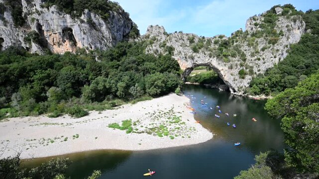 Kayakers passing through the Iconic Pont d'Arc Natural Bridge in Ard&egrave;che, France