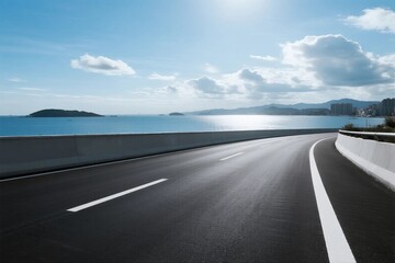 Fototapeta premium Smooth asphalt road extending towards the scenic sea and sky
