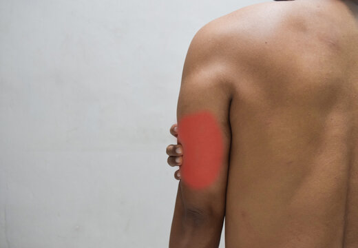 man with pain in shoulder, pain in the human body isolated on beige background