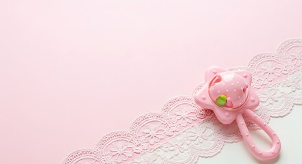 Baby Rattle on Lace and Pink Background