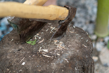 Close-up View of a Hand Axe Resting on a Wooden Stump During Woodworking Activity in a Craftsmans Workshop in the Afternoon Light