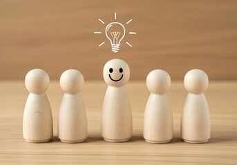 Wooden figures standing in a row with one figure having a lightbulb and smiley face drawn on it