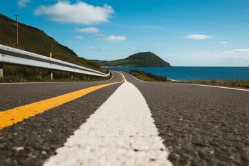 Scenic road by the sea with clear blue sky and mountains